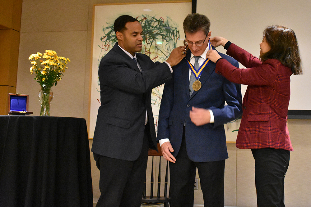 Dean Gallimore and Professor Liu present Professor Lafortune with his medal.