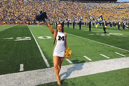 Alexis Roberts cheerleading in the Big House on gameday