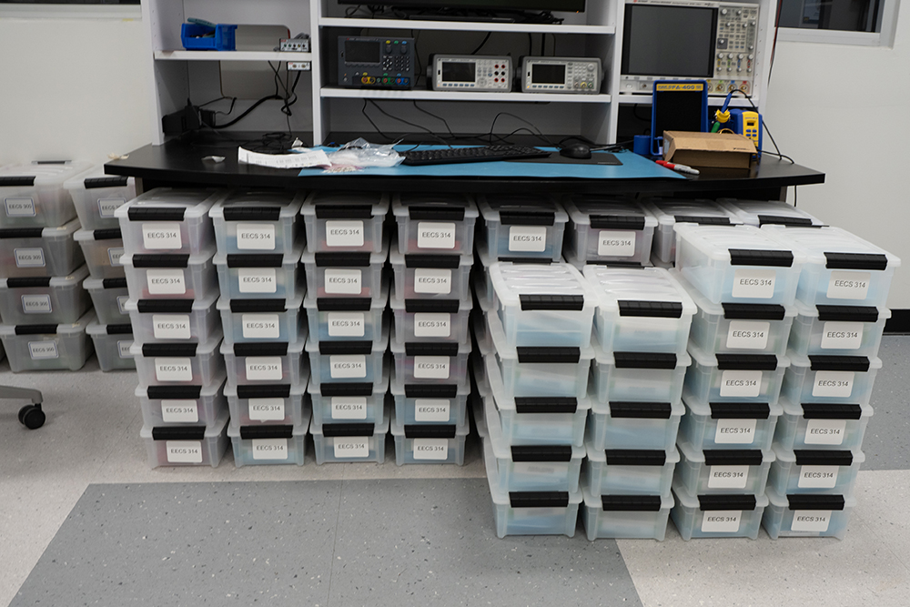 Columns and rows of individual plastic tubs for each lab kit